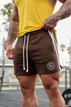 MATERIAL: 100% Cotton. FIT: Fitted. DESIGN: Bodybuilding shorts that offer great flexibility and practicality for a workout session. Inspired by the golden era of bodybuilding, these shorts feature a classic design with a short and stylish length that accentuates your physique. MODEL: The model in the first photo is wearing a size Medium. Weight: 175lb Height: 5'9. Golden Era Bodybuilding, Workout Session, New Launch, Short Leggings, A Workout, Short Shirts, First Photo, Jogger Pants, Bra Tops