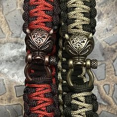 two bracelets that have different colors and designs on them, one is black, the other is red