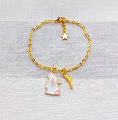 Super cute rabbit charm bracelet perfect for any bunny lover. Great little gift for easter. Perfect when ordered with my matching items that are in my store. *You can select the size required from the drop down menu. *The enamel charm measures approximately 2cms long and is available in pink, white and blue. *The charm, chain and other findings are gold plated. *These can also be personalised with initial charms which can be picked from the menu. ☆☆The bracelet comes presented in a gift bag but gift messages and  wrapping can also be purchased from my store.☆☆ If you have any questions or custom orders please feel free to message me. Rabbit Bracelet, Silver Jewelry With Bunny Design For Gift, Bunny Jewelry, Rabbit Necklace Pendants, Rabbit Necklace, Rabbit Charm, Bunny Lovers, Charm Chain, Cute Rabbit