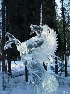 an ice sculpture in the shape of a dragon with wings on it's back