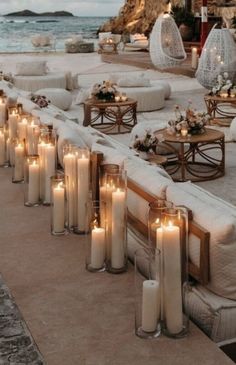 candles are lined up along the edge of an outdoor seating area