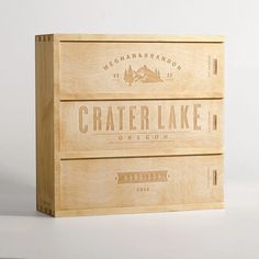 two wooden crates with labels on them sitting next to each other in front of a white background