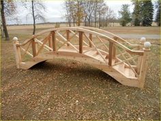 a wooden bridge that is in the grass