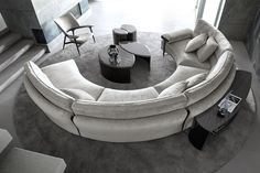 a circular couch sitting on top of a rug in a living room