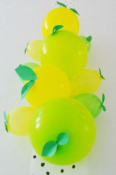 green and yellow balloons with leaves on them