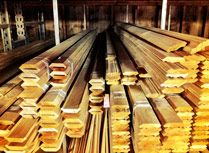 stacks of wooden planks in a factory with metal bars stacked on the floor and one is empty