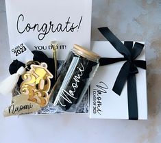 congratulations gift box with personalized items for someone's special occasion, including a wine bottle and tassel