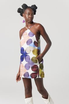 The gorgeous "Yve" shift mini dress is inspired from the iconic 60's mode and features the exclusive colourful kaleidoscope print.    Crafted from quality linen viscose the fabric has a lovely smooth satin sheen and has a beautiful touch to wear.  Dress is fully lined, has side pockets and the straps have sliders for fit adjustment.  Dress up, dress down, style your way, but we think the "Yve" dress looks fun and fabulous with short or long white boots as pictured. Fabric - Quality linen / viscose  Lining - Viscose  Gentle machine or hand wash in cool water, drip dry in shade, iron on reverse side. Do not soak, do not rub, do not tumble dry. Spring Mini Dress With Abstract Print, Spring Abstract Print Mini Dress, Chic Spring Dress With Geometric Pattern, Modern A-line Mini Dress For Spring, Multicolor Geometric Summer Dress, Multicolor Geometric Pattern Summer Dress, Sleeveless Mini Dress With Abstract Print For Spring, Mod Summer Beach Dresses, Summer Mini Dress With Abstract Print