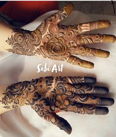 two hands with henna designs on them and the words sabi art written in white