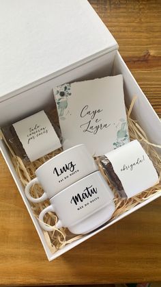 three coffee mugs in a gift box with matching napkins and tags on them