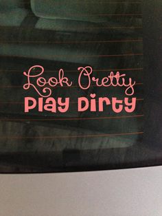 a sticker that says rock pretty play dirty on the back window of a car