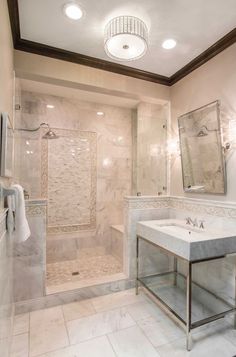 a bathroom with a sink, mirror and shower in it's center wall is shown