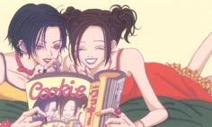 two young women laying on top of each other reading a book in front of them