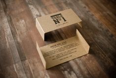 a cardboard box sitting on top of a wooden floor