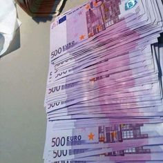 a stack of 500 euros bills sitting on top of a table