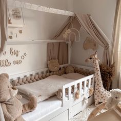 a baby's room with a bed, crib and stuffed animals on the floor