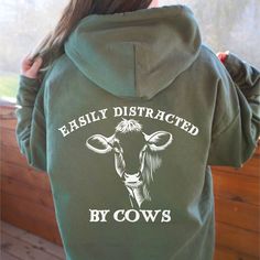 Cute Cow Hoodie Back Print Easily Distracted By Cows Farm Life Funny Animal Sweat Country Farm Love Tee Humor Farmer Unisex Gift Cows Hoodie  This unisex heavy blend hooded sweatshirt is relaxation itself. Made with a thick blend of cotton and polyester, it feels plush, soft and warm, a perfect choice for any cold day. In the front, the spacious kangaroo pocket adds daily practicality while the hood's drawstring is the same color as the base sweater for extra style points. CARE INSTRUCTIONS: Mac Cows Farm, Cow Hoodie, Hoodie Back, Casual Country Outfits, Country Style Outfits, Cute Country Outfits, Western Style Outfits, Cute Shirt Designs, Cute Cow