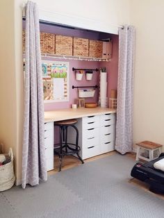 a room with a bed, desk and storage area