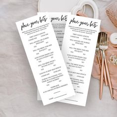 two wedding program bookmarks sitting on top of a table next to some other items