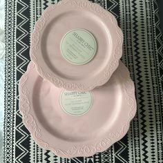 two pink plates sitting on top of a table