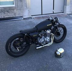 a black motorcycle parked on the street next to a ball