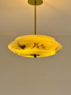 a yellow light hanging from the ceiling in a room