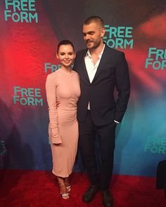 a man and woman are standing together on the red carpet at freeformm's event