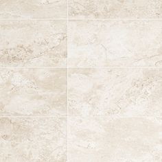 a white tile floor with several different shades of beiges and tans on it