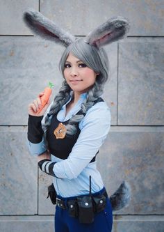 a woman with grey hair and bunny ears holding a carrot