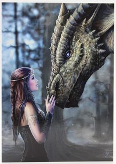 a woman is touching the head of a dragon