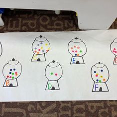 a white paper with different colored dots on it