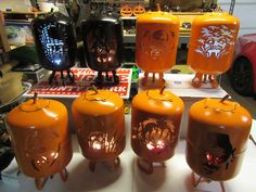 an assortment of orange and black lanterns with faces on them