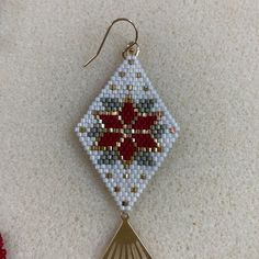 a pair of earrings made out of seed beads