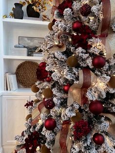 a decorated christmas tree with red and gold ornaments