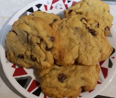 three chocolate chip cookies are on a plate