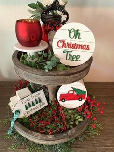 a three tiered tray with christmas decorations on it