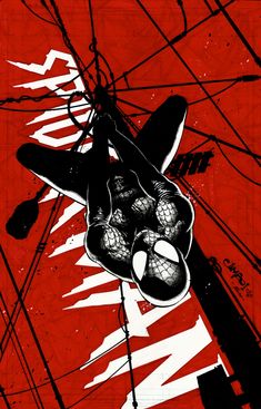 a red and black poster with an image of a spider - man hanging upside down