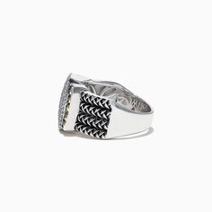 a silver ring with black and white stones on it's sides, set against a white background