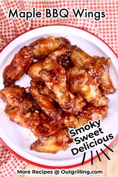 a white plate topped with chicken wings covered in bbq sauce