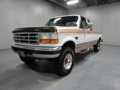 a white and brown truck in a garage