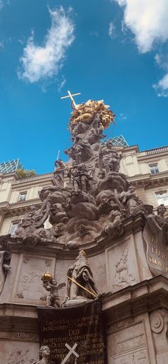 a statue on top of a building with a sky background