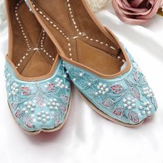 These blue mojaris are the prettiest pair of shoes you'll ever own! Set on, a silk base, these beauties are hand embroidered using Thread work, beads, sequins & faux pearls. The juttis feature a bit of a geometric play. These fashion a jaal design that's edged using thread work, stone and pearl border. The blue & dull Pink with the silvery sequins makes quite a combination. Matching Clutch bag available Available in sizes: 4, 5 and 6 We try to take pictures as normal as we can but Colors may vary due to light setup. Jaal Design, Pearl Border, Matte Pink, Girly Shoes, Star Shoes, Couple Photography Poses, Thread Work, Blue Beads, Womens Slippers