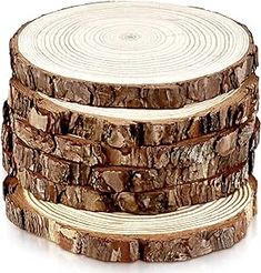 four logs stacked on top of each other in the shape of circles, with brown and white stripes