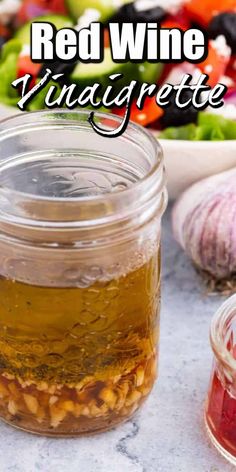 red wine vinaigrette in a jar next to garlic and other vegetables