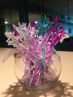 a glass vase filled with pink and purple flowers