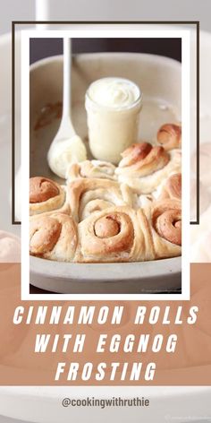 cinnamon rolls with eggnog frosting on a white plate next to a spoon