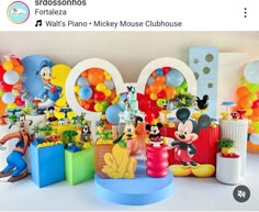 a mickey mouse birthday party with balloons and decorations