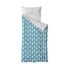 a blue and white bed spread with an owl print on it's coverlet