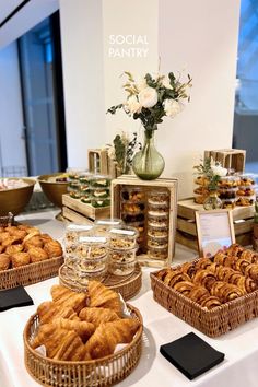 a table topped with baskets filled with pastries