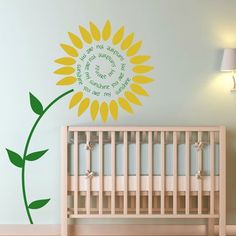 a baby's room with a sunflower wall decal